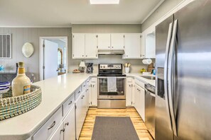Enjoy cooking in this well-equipped kitchen with a stainless steel refrigerator, double oven, and ample counter space.