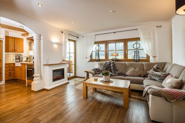 A spacious living room with a fireplace, a sofa, and a coffee table.