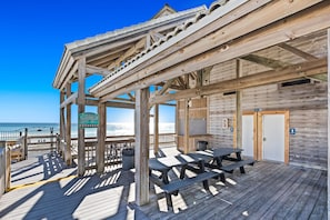 Enjoy access to the beach from this seaside structure, featuring a covered seating area with picnic tables.