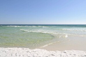 Enjoy the serene beach scene with turquoise waters gently lapping onto the shore.