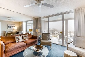 Relax in this stylish living room with a comfortable sofa, armchair, and glass coffee table.
