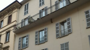A multi-story building with a central entrance, large windows with shutters, and a balcony with metal railings. - Casa Patricia - Como historic center, lakefront (Como)