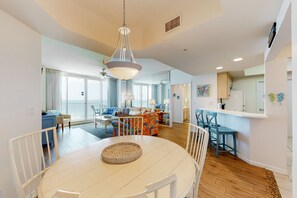 Relax in this inviting living area with a round dining table and cozy seating nook.