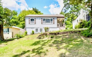 Stroll up to this charming two-story home with a welcoming front porch and beautifully manicured yard.
