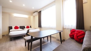 A hotel room with two beds, a dining table, a sofa, and large windows with curtains. - The South Hotel Tokyo (Tokyo)