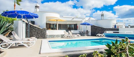 A heated pool, sun loungers