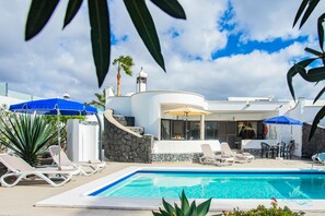 A heated pool, pool loungers