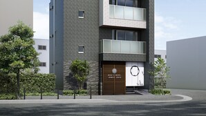 A modern hotel building with a tiled facade, multiple balconies, and a prominent entrance with a wooden door. - WIRES HOTEL James zaka (Tokyo)
