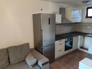 Fridge, electric kettle, cookware/dishes/utensils