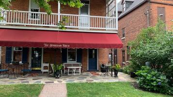 A brick building with a red awning labeled "The Amberson House."