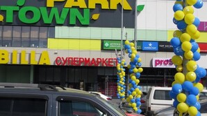 Un centro comercial con un letrero 'PARK TOWN', un supermercado 'BILLA' y un 'Cybermarket'.
