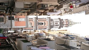 A rooftop with multiple air conditioning units, a car, and a building with a dome structure in the background. - Wide Apartment with Terrace in City Center (Napoli)