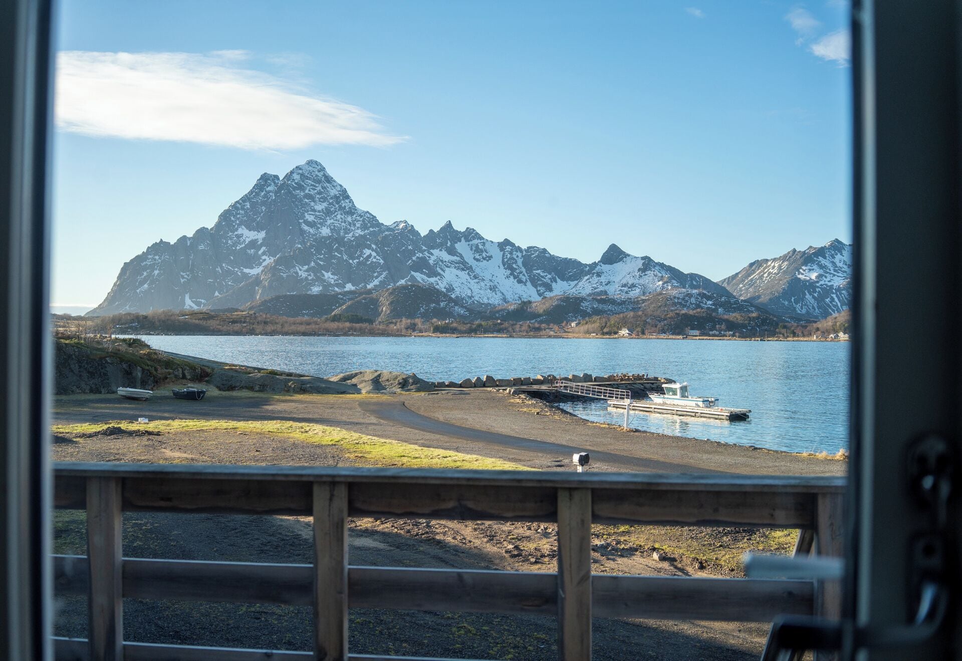 A view of a mountainous landscape with a body of water and a dock.