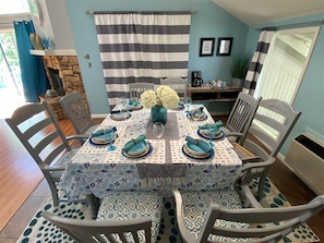 A dining area with a round table set for four, surrounded by chairs. - 4 Bedroom Lakeview home next to Margaritaville (Osage Beach)