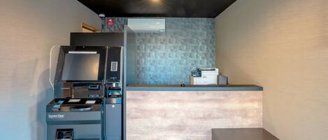 A modern kitchen with a built-in espresso machine, a coffee maker, and a microwave.