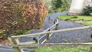 A wooden staircase with a metal handrail leading up to a building entrance. - Cottage in Jedburgh With Stunning Views (Jedburgh)
