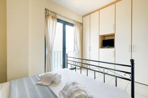 Relax in a spacious room with a large bed, wardrobe, and balcony.