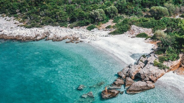 An aerial view of a coastal area with clear turquoise waters, rocky formations, and dense greenery. - Chalet in Leonidio Near Mount Parnon (South Kynouria)