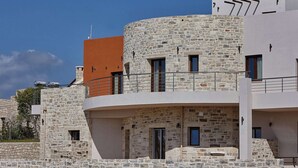 A modern building with stone walls and balconies. - New Beautiful Complex With Villa's and App, Big Pool, Stunning Views, SW Crete (Faistos)