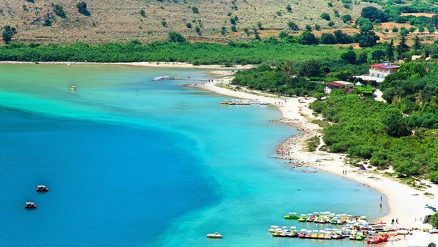 A coastal area with a beach, boats, and a small building. - 2 new Villas With Heated Pool, Rent Separately or Together at Kournas Lake (Apokoronas)