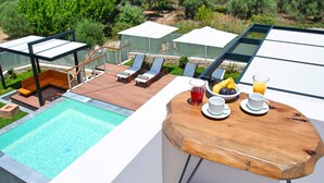 A rooftop terrace with a pool, lounge chairs, and a table with breakfast items. - 2 New Villas Next Each Other, Pool, Rent Separately or Together at Kournas Lake (Apokoronas)