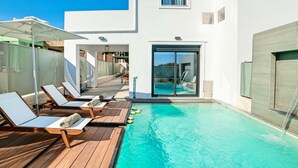 A modern poolside area with lounge chairs and a clear blue pool. - 2 New Villas Next Each Other, Pool, Rent Separately or Together at Kournas Lake (Apokoronas)