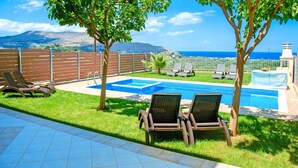A swimming pool with lounge chairs and a view of the sea. - 2 Villas Next to Each Other with Pool & Sea View (Apokoronas)