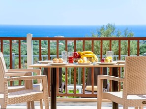 A table set with breakfast items on a balcony overlooking the sea. - 3 Villas Next to Each Other with Pool & Sea View (Apokoronas)
