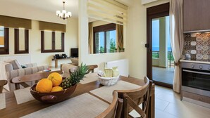 A modern living room with a dining area, a kitchen, and a balcony with a view. - Villa with Private Pool near Sea & Arkadi Monastery on NW Coast (Rethymno)