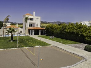 A residential area with a house featuring a balcony and a swimming pool.