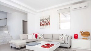 A modern living room with a sectional sofa, a coffee table, and a rug. - Villa in Rhodes With Infinity Pool & BBQ (Rhodes)