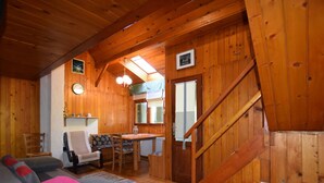 A cozy cabin interior with a wooden interior, a sofa, a dining table, and a staircase. - Restful Holiday Home in Vrbovsko (Vrbovsko)