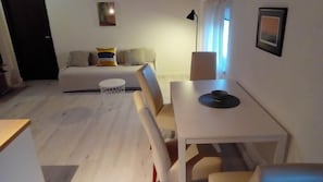 Relax in this serene living space with a sofa set, dining table, and single chair.