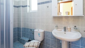 A bathroom with a shower, toilet, and sink. - Hillside Villa in Bali With Private Pool (Mylopotamos)