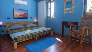 A bedroom with a bed, a chair, a desk, a window with blinds, and a wall-mounted air conditioner. - Adorable Holiday Home With Private Swimming Pool & Terrace (Visnjan)