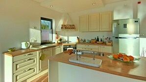 A modern kitchen with white cabinets, a stainless steel refrigerator, and a wooden countertop.
