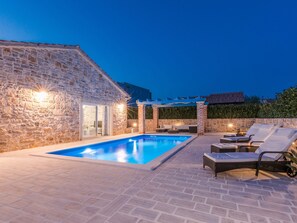 A stone building with a swimming pool and outdoor seating area. - Modern Villa in Sukosan With Private Swimming Pool (Sukosan)