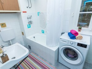 Villa | Bathroom | Bathtub, hair dryer, towels