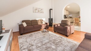 A modern living room with a sofa set, a coffee table, and a fireplace. - Apartment in Vrsi Near the Sea (Vrsi)