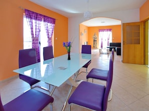 Enjoy meals in this dining area with a glass-top table and comfortable seating.