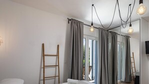 A bedroom with a bed, a wooden ladder, and a mirror reflecting the room. - Modern Countryside Villa Near the Sea, Private Swimming Pool, Lovely Guesthouse (Polaca)