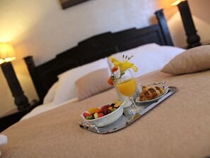A neatly arranged breakfast tray on a bed with a white pillow and a black headboard. - Villa on an Exclusive Location in Dubrovnik With Pool (Dubrovnik)