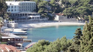 A coastal hotel with a beach view, a pool, and a restaurant. - Dubrovnik Apartment With Private Terrace (Dubrovnik)