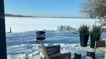 Sit and enjoy the serene view of the frozen lake from this outdoor seating area.