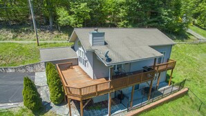 A two-story house with a covered deck and a satellite dish. - Blue Ridge Daze ~ Mtn Vista, Fireplace, Fire Pit, Pet Friendly, 30 mins to AVL. (Burnsville)