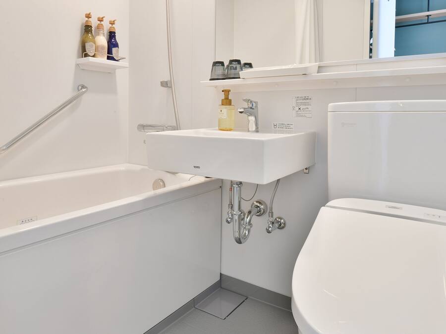 A modern bathroom with a bathtub, a sink, and a toilet.