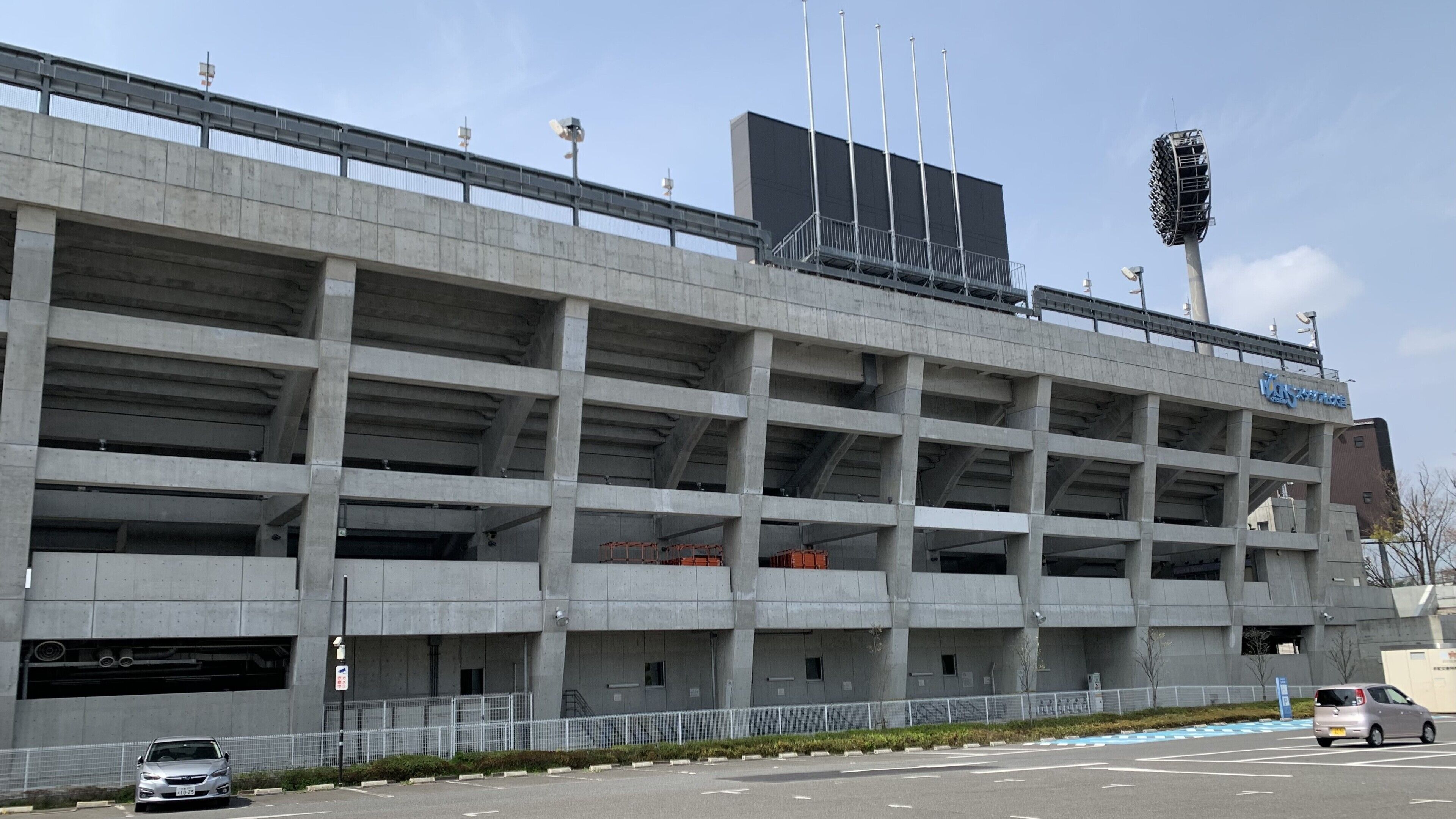 A multi-level parking garage with concrete pillars and a flat roof.