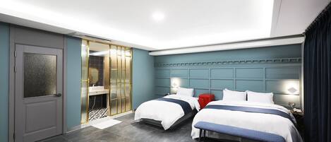 A modern hotel room with two beds, a desk, and a seating area.
