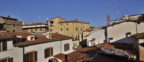 A densely packed urban area with traditional architecture, featuring terracotta roofs and a mix of building heights.