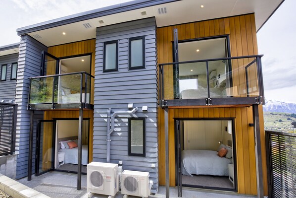 Enjoy the scenic views from the balcony with glass railings, featuring a distant mountain landscape.